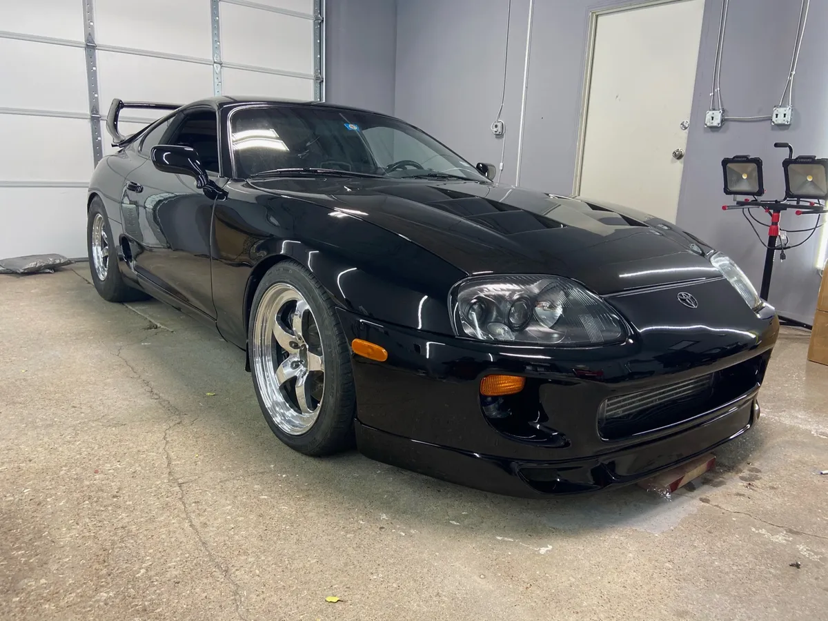 Black Toyota Supra photographed inside the workshop